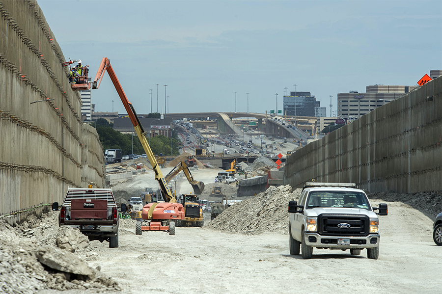 Work trucks and machinery on roadway construction